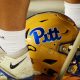 A Pitt football helmet sits at a player's feet during a timeout against Virginia Tech on Saturday, Sept. 30, 2023 in Blacksburg, Virginia. (Mitchell Northam / Pittsburgh Sports Now.)